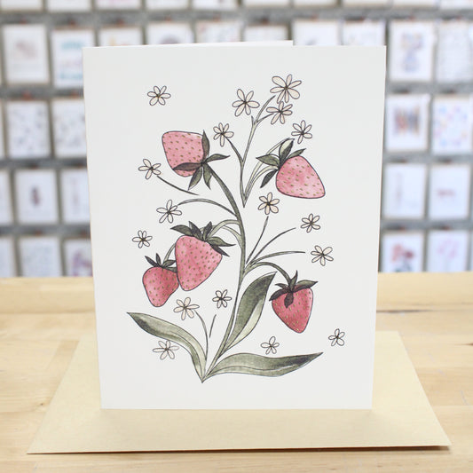 Hand crafted greeting card with hand drawn and water colored growing strawberries and white flowers. 