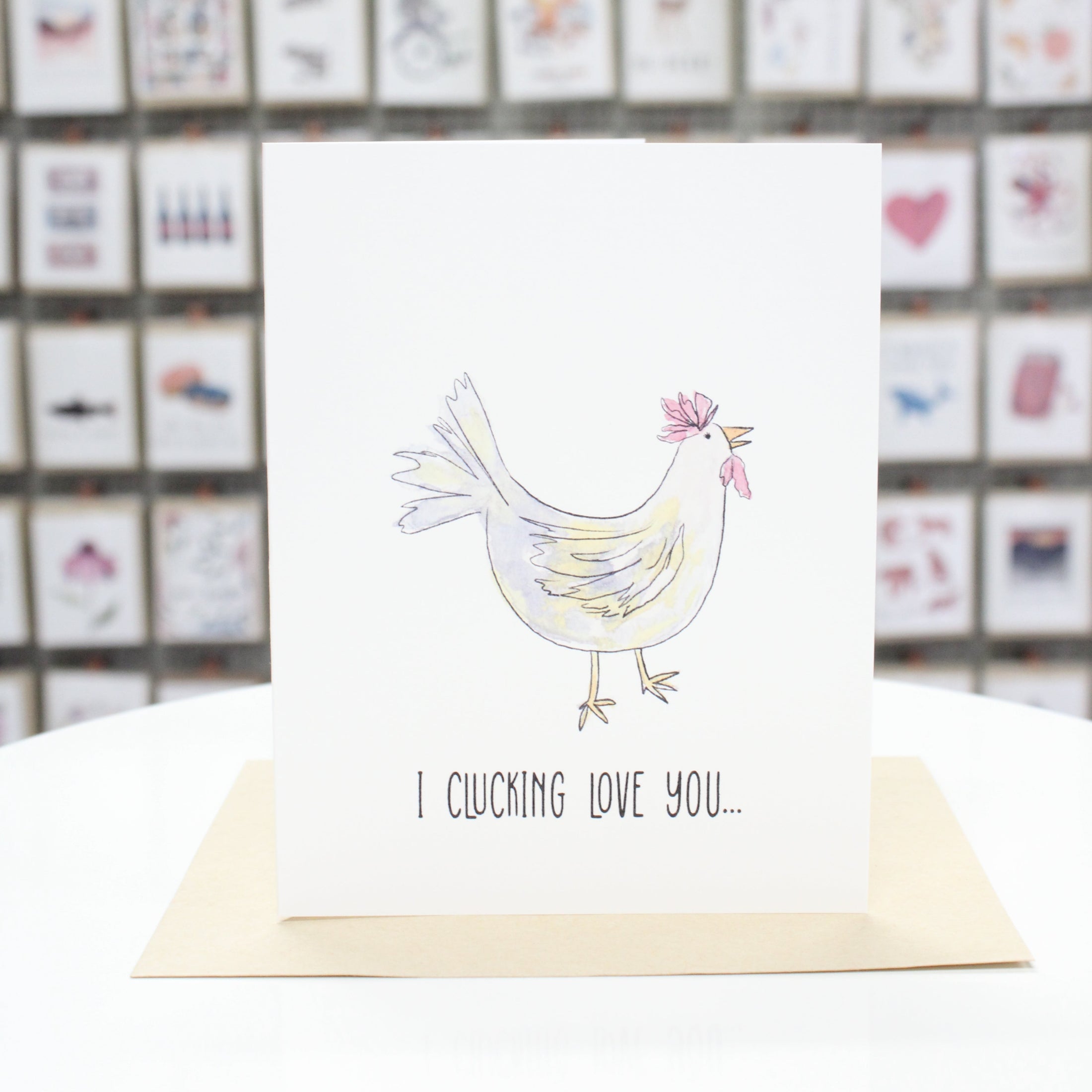 Hand crafted greeting card with drawn and water colored chicken. Card stating, "I clucking love you" at the bottom. 