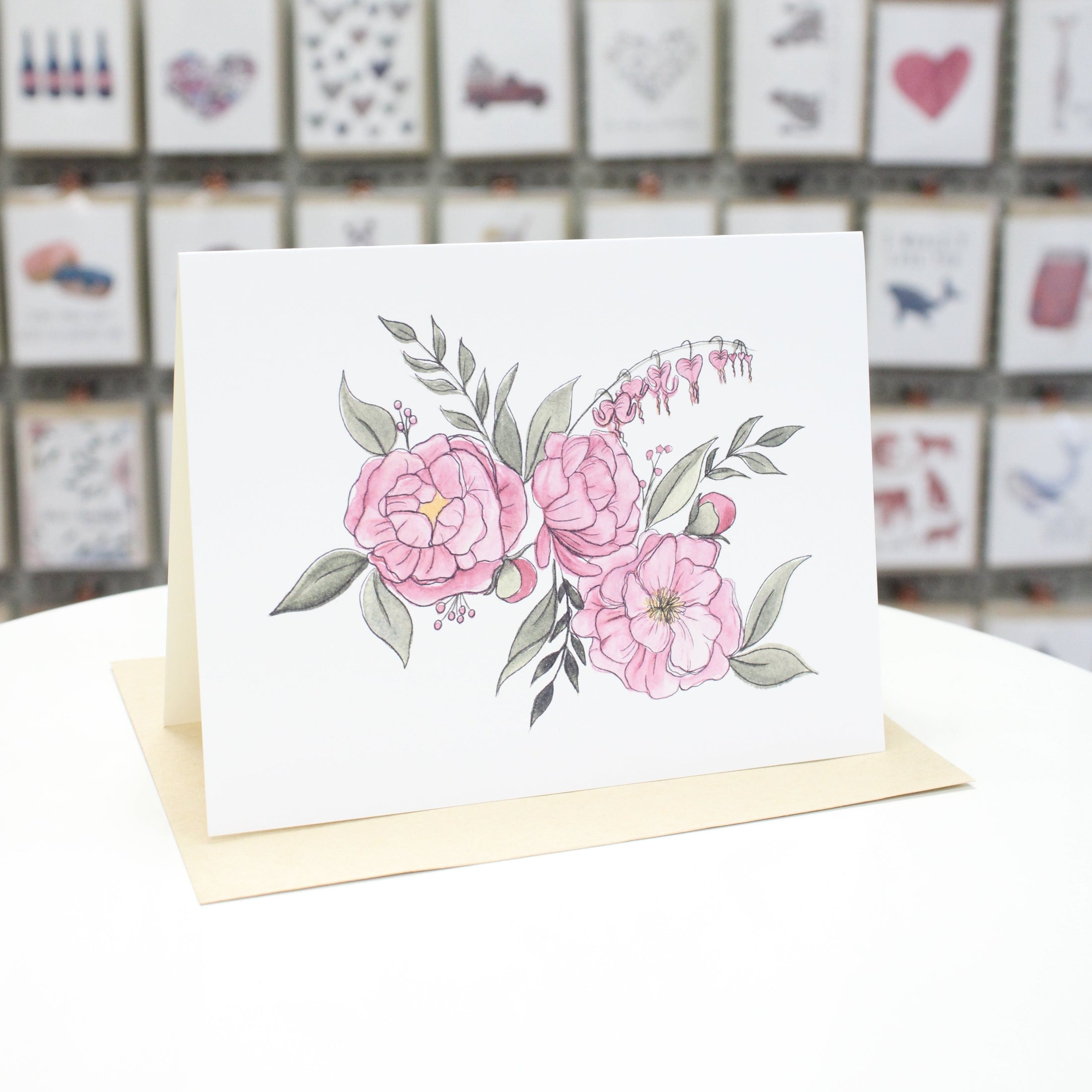 Hand crafted greeting card with hand drawn and water colored pink flowers  and green leaves. 