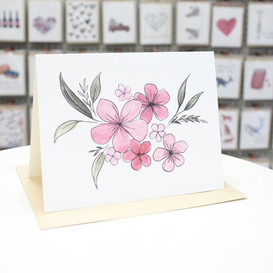 Hand crafted greeting card with hand drawn, water colored pink flower and leaves motif.
